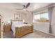 Bright bedroom with wood-framed bed and ceiling fan at 1518 N 62Nd Pl, Mesa, AZ 85205