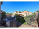 Home's backyard with a pool, grass, and landscaping at 16370 W Adams St, Goodyear, AZ 85338