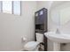 Clean bathroom with pedestal sink, toilet, and storage cabinet at 16370 W Adams St, Goodyear, AZ 85338