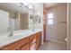 Bathroom with double vanity, shower, and tile flooring at 16370 W Adams St, Goodyear, AZ 85338