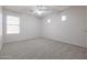 Well-lit bedroom with carpeted floors and large window at 16370 W Adams St, Goodyear, AZ 85338