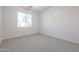 Empty bedroom with carpeted floors and a window at 16370 W Adams St, Goodyear, AZ 85338