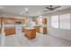 Kitchen with island, wood cabinets, and tile flooring at 16370 W Adams St, Goodyear, AZ 85338