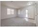 Bright living room with plenty of natural light and neutral carpet at 16370 W Adams St, Goodyear, AZ 85338