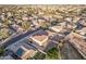 Aerial view of two story house with solar panels and large backyard in a residential neighborhood at 16765 W Hadley St, Goodyear, AZ 85338