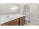 Clean bathroom with tub shower and wood cabinets at 16765 W Hadley St, Goodyear, AZ 85338