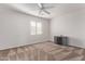 Bedroom with ceiling fan and media console at 16765 W Hadley St, Goodyear, AZ 85338