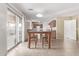 Bright dining area with wooden table and chairs, adjacent to kitchen at 16765 W Hadley St, Goodyear, AZ 85338