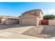 Two-story house with beige exterior, two-car garage, and landscaped front yard at 16765 W Hadley St, Goodyear, AZ 85338