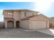 Two-story house with beige exterior, two-car garage, and landscaped front yard at 16765 W Hadley St, Goodyear, AZ 85338