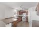 Well-lit kitchen with wood cabinets, tiled floors and modern appliances at 16765 W Hadley St, Goodyear, AZ 85338