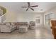 Spacious living room with tiled floors, neutral colors, and comfortable seating at 16765 W Hadley St, Goodyear, AZ 85338