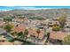 Aerial view showing a neighborhood with houses, mature trees, and a mountain backdrop at 17014 E De Anza Dr, Fountain Hills, AZ 85268