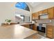 Kitchen with wood cabinets and arched window at 17014 E De Anza Dr, Fountain Hills, AZ 85268