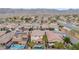 Aerial view of the house, pool, and neighborhood with mountains in the background at 1715 W Satinwood Dr, Phoenix, AZ 85045