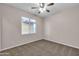 Simple bedroom with carpet, ceiling fan and window at 1715 W Satinwood Dr, Phoenix, AZ 85045