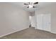 Spacious bedroom with carpet, ceiling fan and double doors at 1715 W Satinwood Dr, Phoenix, AZ 85045