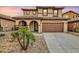 Two-story house with tan exterior, arched entryway, and two-car garage at 1715 W Satinwood Dr, Phoenix, AZ 85045