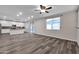 Open concept kitchen with white cabinets, island, and tile backsplash at 1715 W Satinwood Dr, Phoenix, AZ 85045