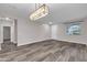 Open living room with gray vinyl flooring and entryway at 1715 W Satinwood Dr, Phoenix, AZ 85045