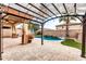 Relaxing pool area with pergola, lush landscaping, and a waterfall feature at 1715 W Satinwood Dr, Phoenix, AZ 85045