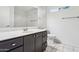 Bathroom with dark vanity, toilet, and shower/tub combo at 17243 N 16Th St # 1, Phoenix, AZ 85022