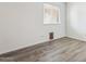 Bright bedroom with wood-look floors and a window with blinds at 17243 N 16Th St # 1, Phoenix, AZ 85022