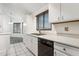 Kitchen with white cabinets, black appliances, and a view of the dining area at 17243 N 16Th St # 1, Phoenix, AZ 85022