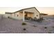 Spacious backyard with a covered patio and fire pit at 17299 W Dahlia Dr, Surprise, AZ 85388