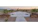 Community cornhole area with stone retaining walls at 17299 W Dahlia Dr, Surprise, AZ 85388