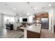 Open floor plan kitchen with island, stainless appliances, and living room view at 17299 W Dahlia Dr, Surprise, AZ 85388