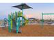 Modern playground structure with slide and swings at 17299 W Dahlia Dr, Surprise, AZ 85388