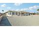 Backyard view of home showing covered patio and gravel at 17635 N Buntline Dr, Sun City West, AZ 85375