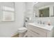 Clean bathroom with vanity, toilet, and window at 17635 N Buntline Dr, Sun City West, AZ 85375