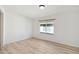 Simple bedroom with light wood floors and a window at 17635 N Buntline Dr, Sun City West, AZ 85375