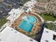 Overhead view of a well-equipped community pool with lap lanes, seating, and vibrant landscaping at 17635 N Buntline Dr, Sun City West, AZ 85375