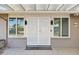 Front entrance with white security door and pergola at 17635 N Buntline Dr, Sun City West, AZ 85375