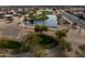 Aerial photograph features the golf course with a pond and lush green fairways surrounded by desert landscaping at 17635 N Buntline Dr, Sun City West, AZ 85375