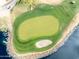 Dramatic aerial view of a golf green on the water with the sand trap, set against a backdrop of water and rocks at 17635 N Buntline Dr, Sun City West, AZ 85375