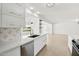 Bright kitchen features white cabinets, quartz countertops, and a golf course view at 17635 N Buntline Dr, Sun City West, AZ 85375