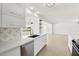 Stylish kitchen with white cabinets and a gold faucet at 17635 N Buntline Dr, Sun City West, AZ 85375