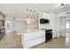 Modern kitchen island with white cabinets and gold lighting fixtures at 17635 N Buntline Dr, Sun City West, AZ 85375