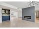 Living room with fireplace, built-in bar, and modern lighting at 17635 N Buntline Dr, Sun City West, AZ 85375