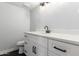 Modern bathroom with white cabinets, black hardware, and sleek countertops at 1839 E Indigo St, Mesa, AZ 85203