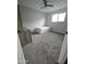 Bedroom with carpet flooring, ceiling fan and built-in shelving at 1839 E Indigo St, Mesa, AZ 85203