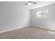 Bright bedroom features neutral paint, window for natural light, and ceiling fan at 1839 E Indigo St, Mesa, AZ 85203