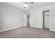 Bedroom with carpet, ceiling fan, and access to another room at 1839 E Indigo St, Mesa, AZ 85203