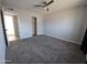 Spacious bedroom with carpet, ceiling fan and mirrored closet doors at 1839 E Indigo St, Mesa, AZ 85203