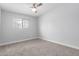 Carpeted bedroom features a ceiling fan and window providing natural light at 1839 E Indigo St, Mesa, AZ 85203