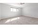 Bright, carpeted bedroom features a ceiling fan and a window for natural light at 1839 E Indigo St, Mesa, AZ 85203